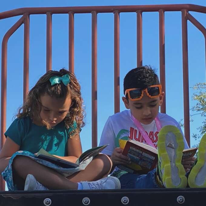 two kids reading a book